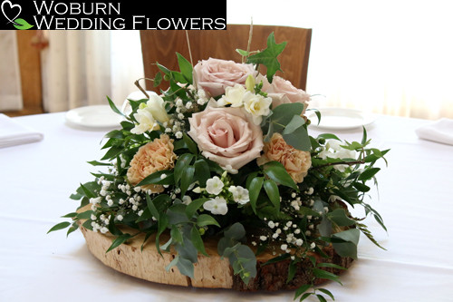 Posy arrangement of Quicksand roses, phlox,freesia, carnations, gypsophilia, ivy trails with mixed greenery.