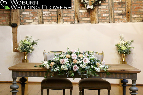 Registrar arrangement of Quicksand roses, phlox, stocks, gypsophilia and mixed greenery.