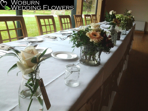 Top table jars including Roses, Germini, Hydrangea and greenery