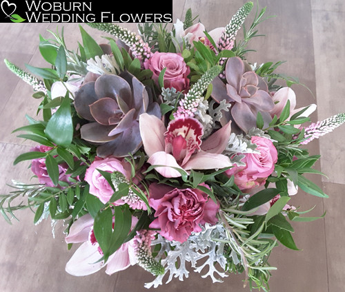 Textured hand tied bouquet with Succulents and Orchids.