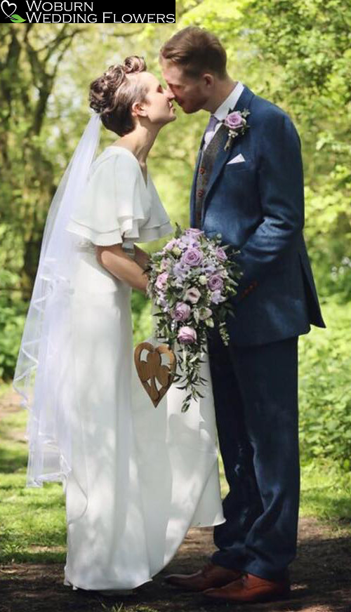 Soft Lilac shower bouquet and buttonhole for an outdoor ceremony at the Milling Barn