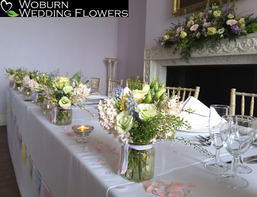 Spring flower arrangements in glass jars at Moggerhanger Park.