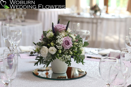 Ivory pot arragment containing Roses, Lisianthus, Freesia, Veronica and Gypsophilia.