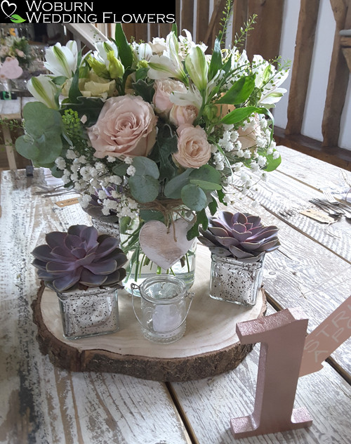 Rose, Gypsophilla, Lizzianthus and Alstromeria vase with planted succulents
