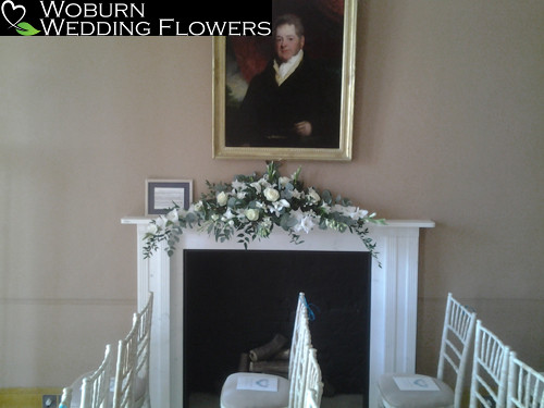 White mantelpiece arrangement in the ceremony room.