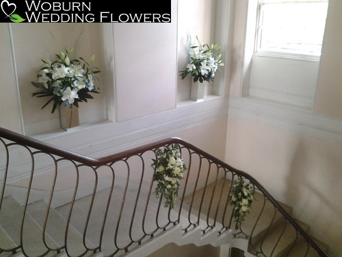 Rose and lilly arrangements decorating the grand staircase.