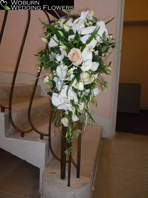 Rose and lilly arrangement at the bottom of the grand staircase.