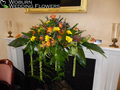 Colourful mantelpiece arrangement in the ceremony room.