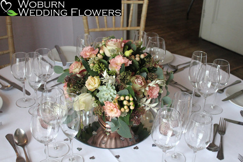 Table arrangement of succulents, upper secret and sweet pearl avalanche roses, lizzianthus. eucalyptus pods and bleached ruscus.