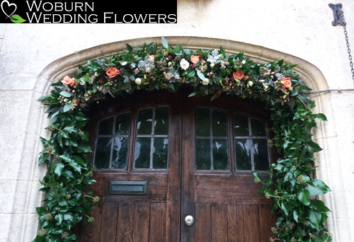 Entrance decorated with Roses, Hypericum, Lizzianthus and Dusty Miller.