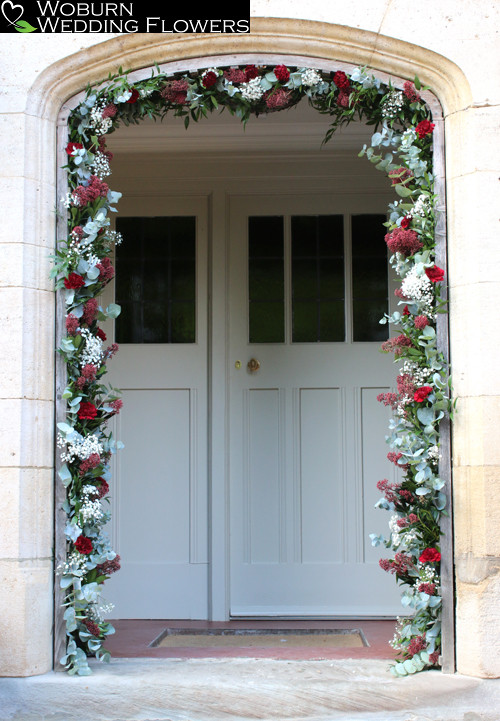 Entrance archway decorated with Clove Carnations, Skimmia and Gypsophilia.