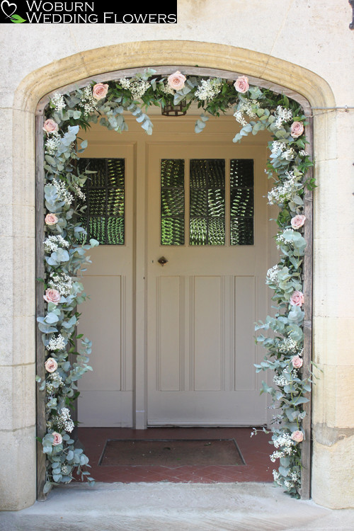 Entrance arch decorated with Eucalyptus, Quicksand Roses and Gypsophilia.