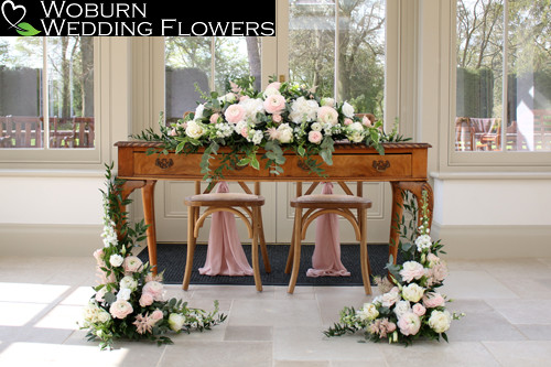 Ranuculus, double tulip, lisianthus, spray roses, stocks and astilbe registrar table decor.