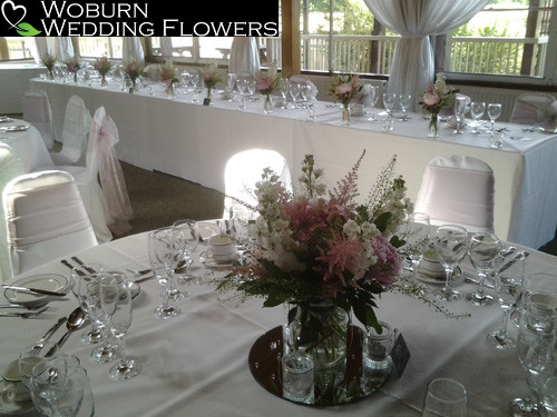 Stocks and astilbe table arrangement with rose and astilbe arrangements on the top table