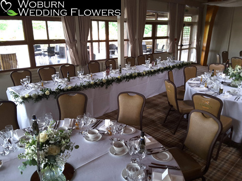 Gypsophilia and freesia pot and rose top table garland