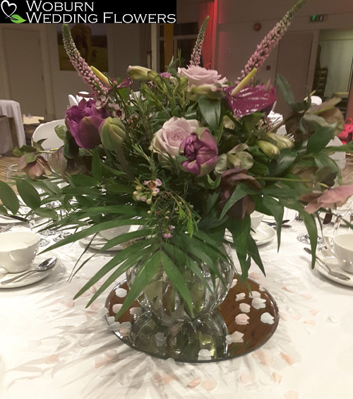 A vase arrangement of veronica, tulips, roses and alstromeria