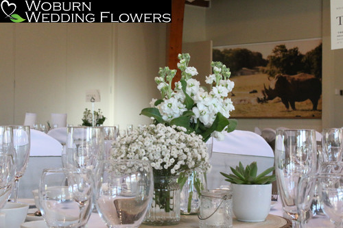 White scented flowers with succulent table grouping.