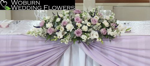 Top table arrangement of memory lane Roses, Gladioli, Veronica, Lisianthus and Gypsophilia.