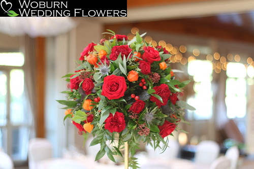 Autumnal table centre including red Roses.