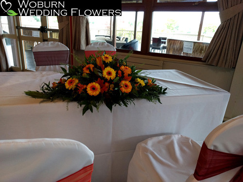 Germini, freesia, hypericum and crispidia registrars table arrangement