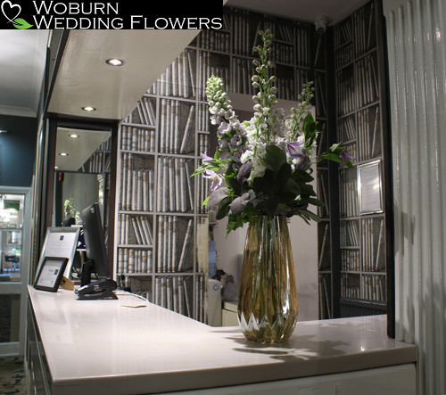 Modern reception arrangement using delphinium, stocks and clematis