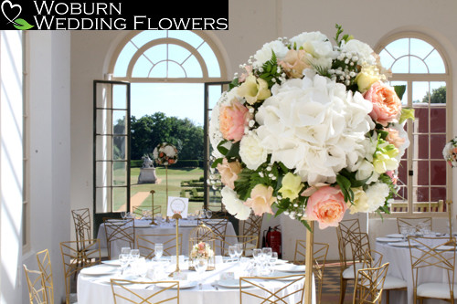 Coral and white scheme on gold tall stands in the Orangery.