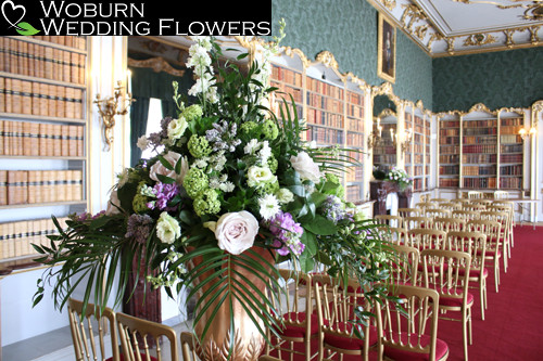 Large pedestal arrangement including Early Grey Roses in the library.