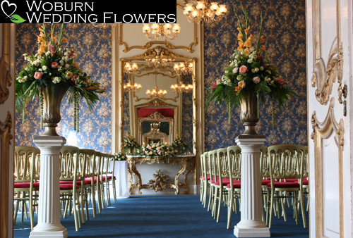 Large urns of gladioli, roses and hydrangea.